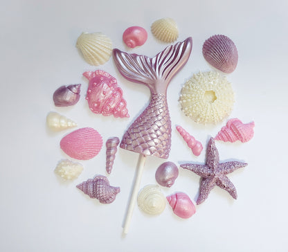 Mermaid tail and shells in lilac, rose and cream colours. Edible chocolate cake decorations