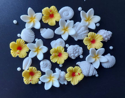 Assorted small shells and tropical flowers in yellow and white colours. Edible fondant icing cake decorations / topper.