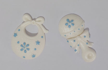 Baby rattle and bib in white and pink. Edible fondant icing cake decorations