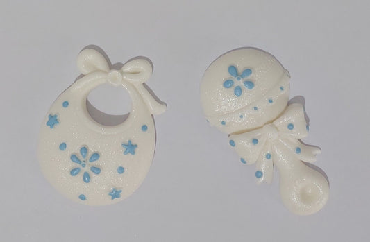 Baby rattle and bib in white and pink. Edible fondant icing cake decorations