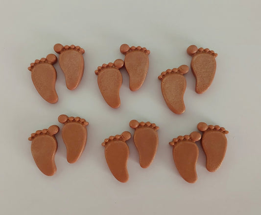 Brown baby feet, edible fondant cake decorations.