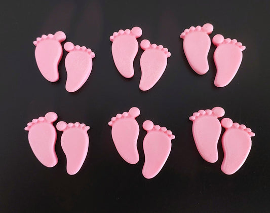 Pink baby feet, edible fondant cake decorations.