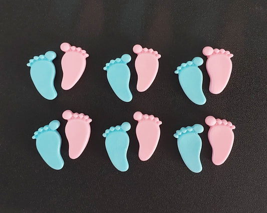 Pink and blue baby feet, edible fondant cake decorations.