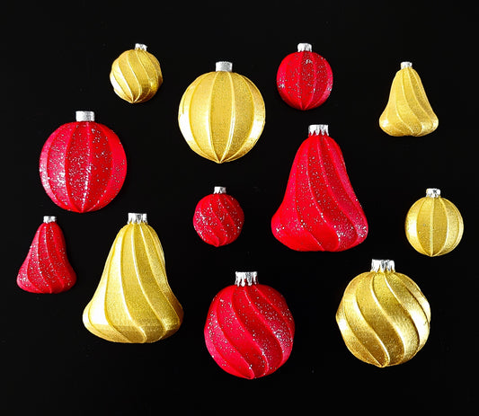 Red and gold Christmas ornaments on a black background