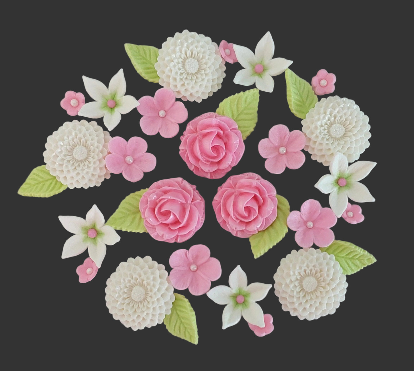 Assorted sugar flowers and leaves in pink and white colours, edible cake decorations