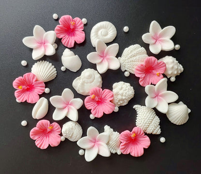 Assorted small shells and tropical flowers in pink and white colours. Edible fondant icing cake decorations / topper.