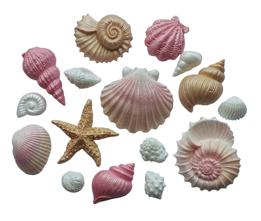 Collection of pretty edible icing seashells and a starfish in rose gold, white and pink colours.